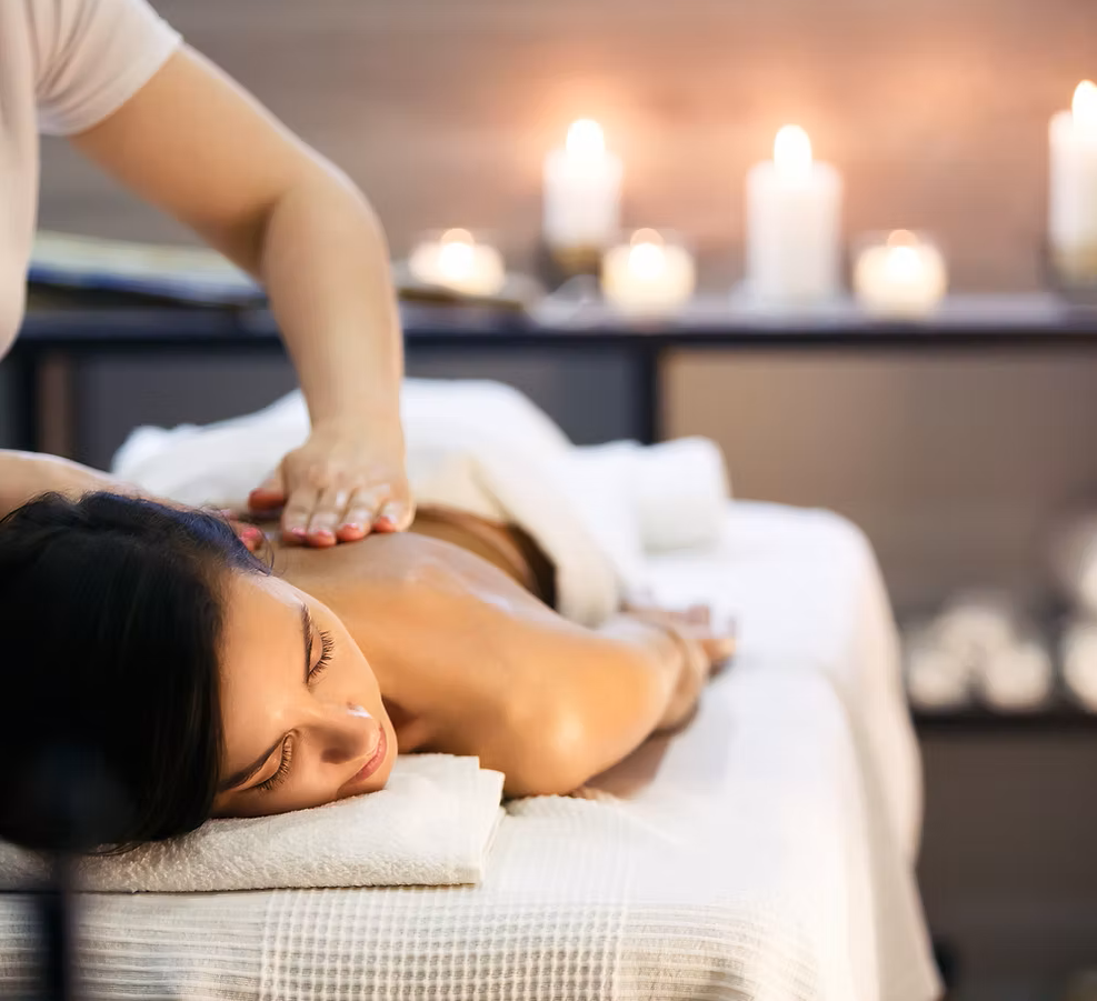 Relaxing massage treatment with warm candles in the background